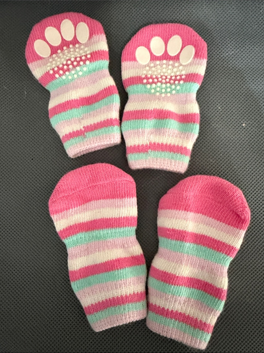Pink, blue, & white striped pet socks feature rubberized grip pads